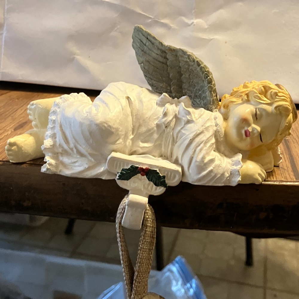 Like new sleeping angel hanging on the fireplace or mantel. Either way canvas
